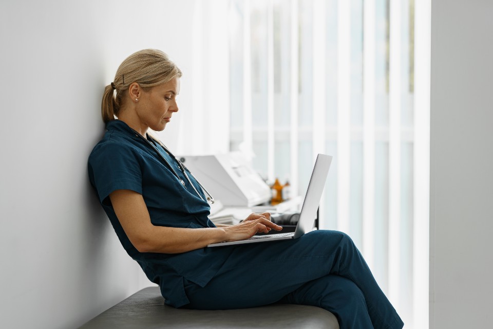 Female healthcare worker using laptop